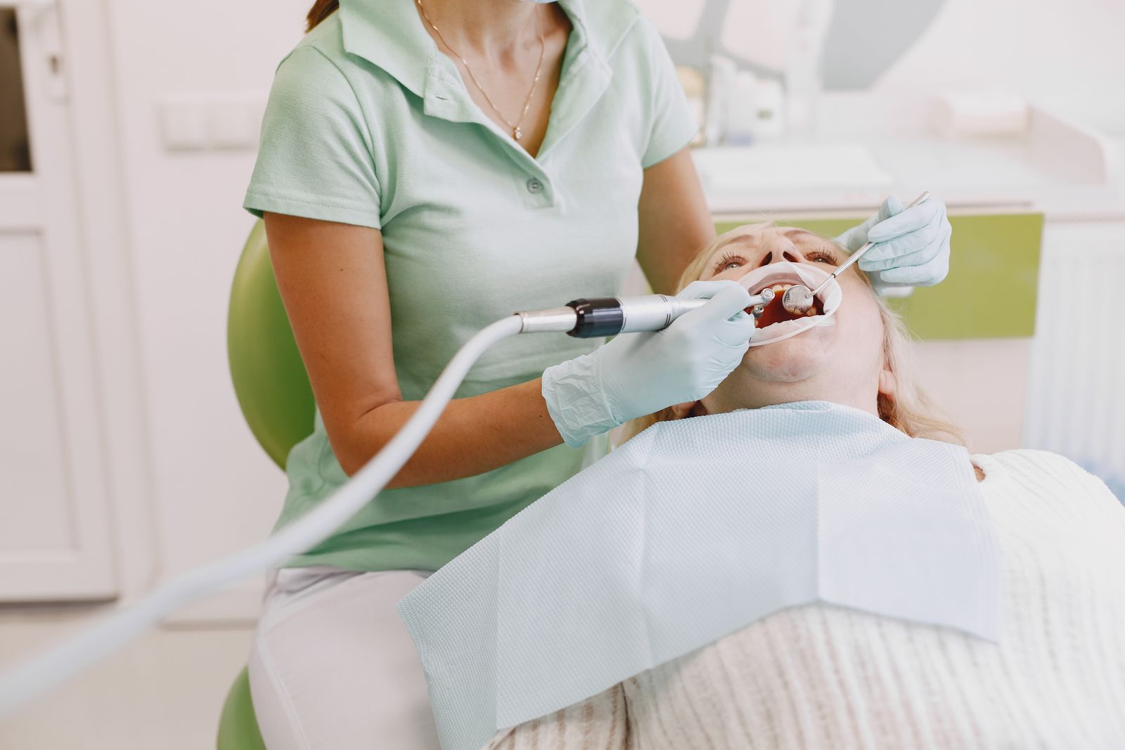 Dental hygienist cleaning a patient's teeth