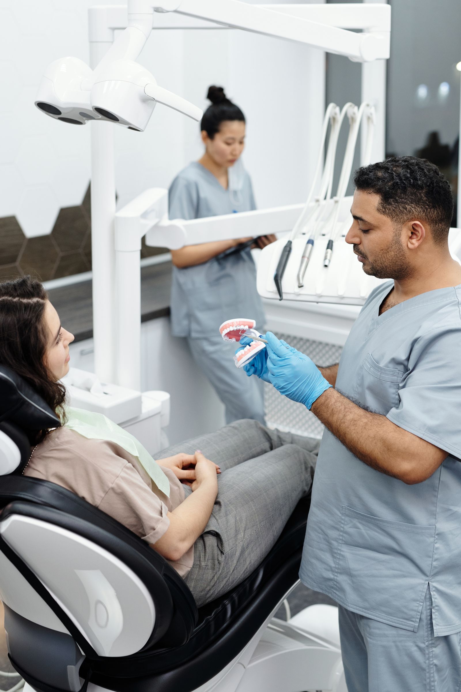 Dentist explaining a dental procedure to a patient in a modern clinic